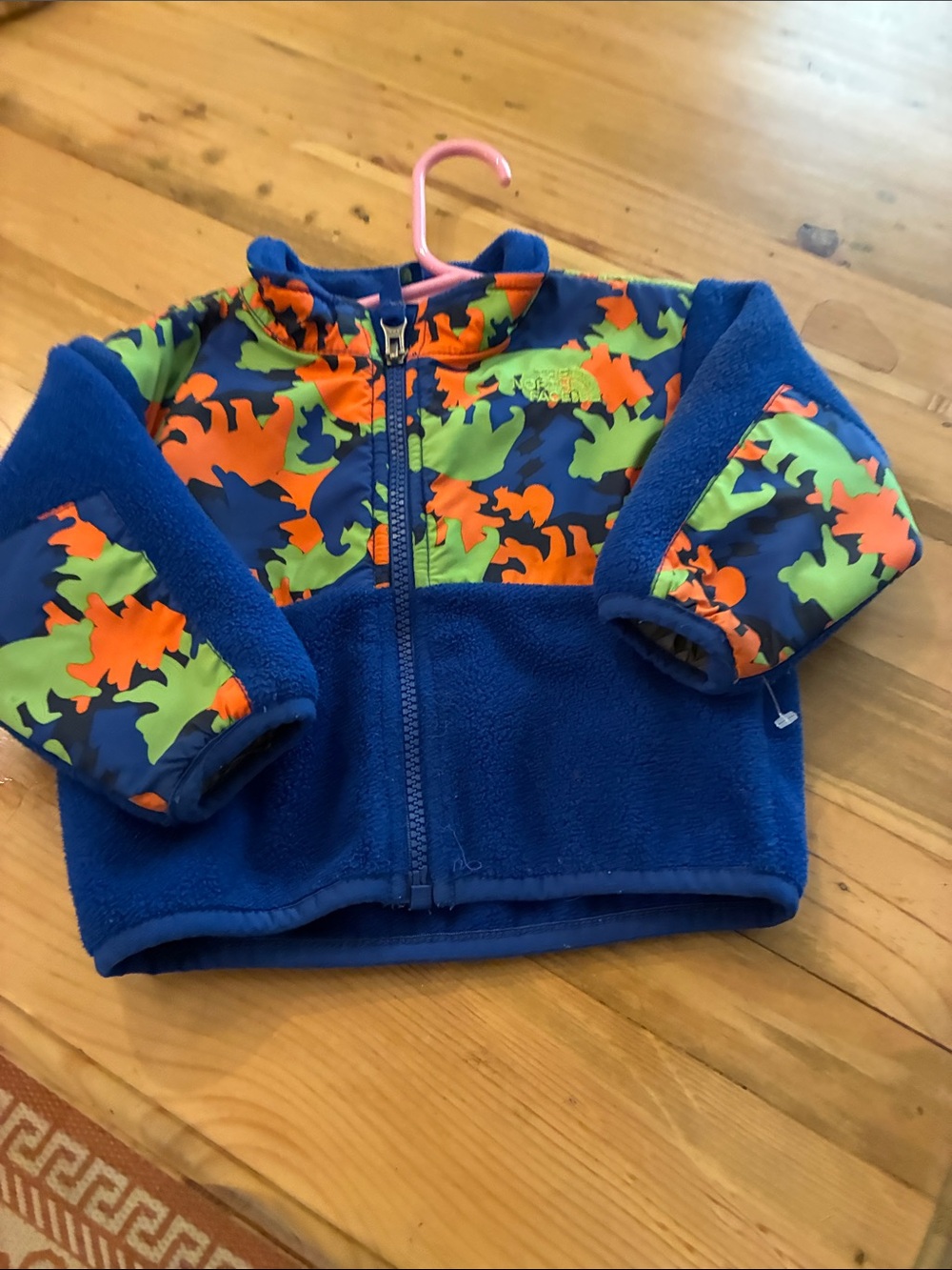 The North Face Blue Fleece Jacket with Orange and Green Dino Pattern